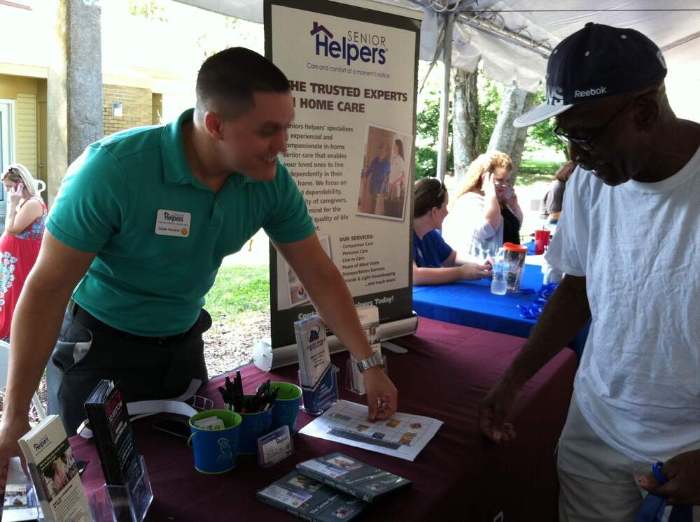 attendee at resident fair visiting vendor booth