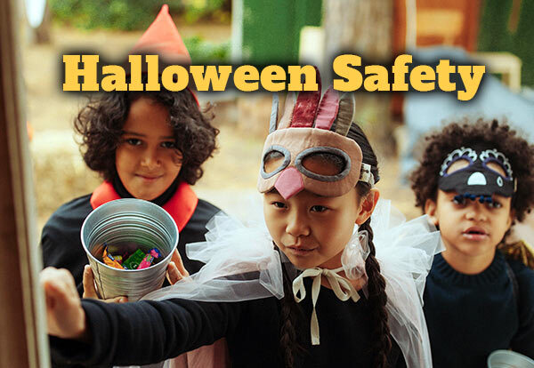 Halloween Safety. Three children are in Halloween costumes and knocking on a door to trick-or-treat.